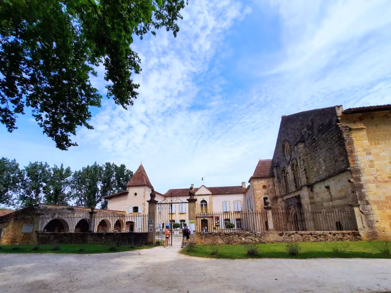 Cyclistes devant l'entrée de l'Abbaye de Flaran