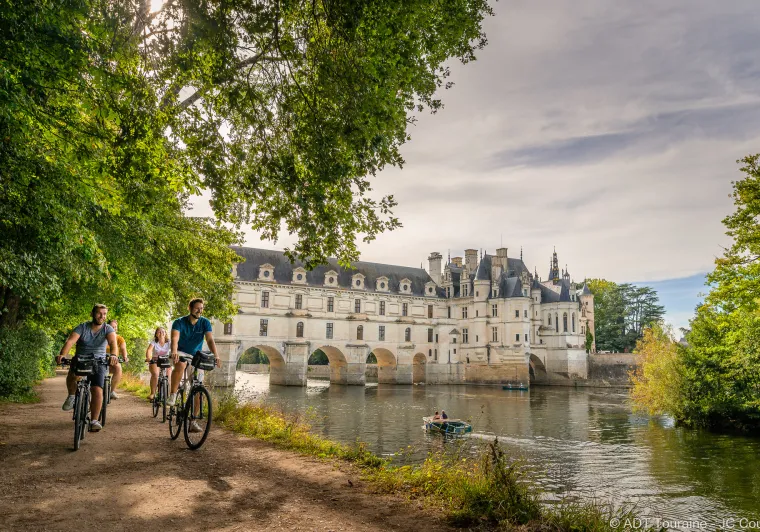 Cyclistes au bord du Cher devant le château de Chenonceau