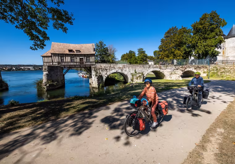 Cyclistes en voyage devant le vieux Moulin à colombage de Vernon