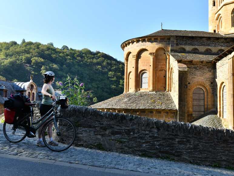 Cyclistes devant l'abbatiale de Conques